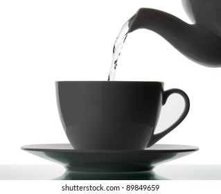 Teapot Pouring Boiling Water Into A Cup. Silhouette