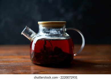 Teapot of tea standing on wooden table