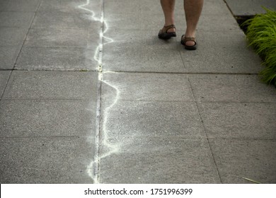 Tear Gas Canister Burn Marks On A Sidewalk After A Riot, With Space For Text On The Rifht