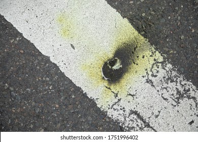 Tear Gas Canister Scorch Marks On A Pedestrian Crosswalk After A Riot