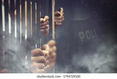 tear gas thrown to the protesters behind bars - Shutterstock ID 1794729100