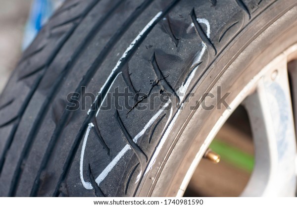 Tear marks on bald tires, car use unsafe tyre\
dangerous for vehicle.