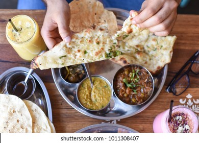 Tearing Apart Naan Bread At Indian Restaurant