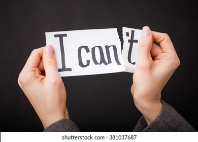 Tearing up " I Can't" sign