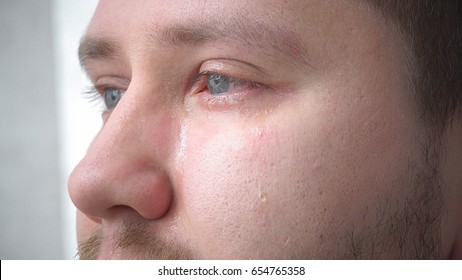 Tears In The Eyes Of An Adult Man Crying Closeup