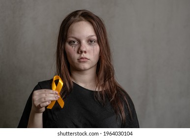 Tear-stained Teen Girl Holds Yellow Ribbon. Concept Of Suicide Problems And Their Prevention 