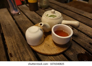 A teaset on the rustic table.
