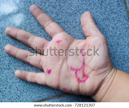 Teasing face in Asian girl's palm