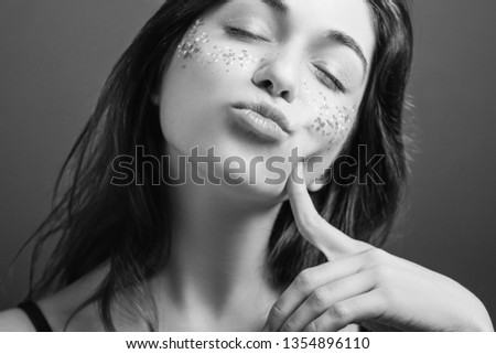 Teasing woman nature. Pout lips. Finger at cheek. Closed eyes. Black and white narcissist portrait.