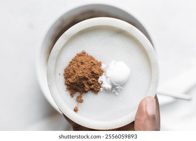 Teaspoon of cinnamon and allspice on a white tray, Saigon cinnamon, cinnamon powder on a marble tray - Powered by Shutterstock