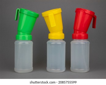 Teat Dip Cups For Cattle After Milking. Udder Disinfection. Three Colored Bottles For Hygiene And Health Care Of Cow's Udder