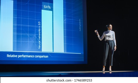 Tech Conference Stage: Visionary Female Speaker Talks About Product. Neural Networks, Artificial Intelligence, Big Data And Machine Learning. Infographics On Big Screen. Live Startup Business Event