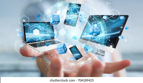 Tech devices connected to each other by businessman on blurred background 3D rendering - Shutterstock ID 704189425