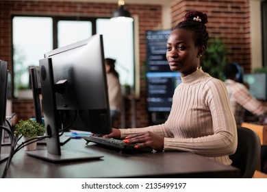 Tech engineer creating machine learning software to be used as an autonomous virtual entity. Confident african american network developer engineering application for company database.