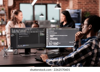Tech engineer programming server code algorithm on computer, typing sever data in it agency office. Software developer working on new user interface with online system to create algorithm.