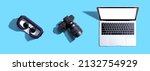 Tech gear theme with vr headset, dslr camera and laptop computer