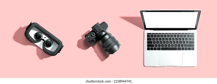 Tech gear theme with vr headset, dslr camera and laptop computer