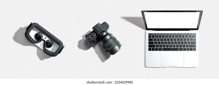 Tech gear theme with vr headset, dslr camera and laptop computer - Powered by Shutterstock