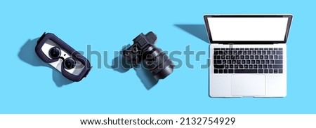 Tech gear theme with vr headset, dslr camera and laptop computer