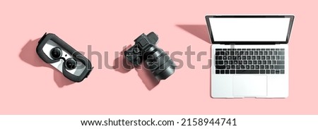 Tech gear theme with vr headset, dslr camera and laptop computer