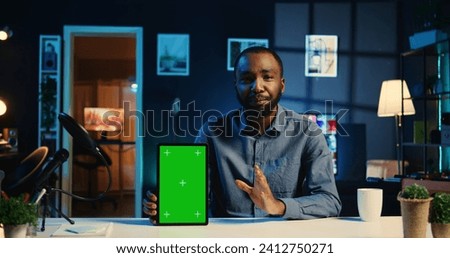 Tech online star filming chroma key tablet unboxing, giving reasons to purchase. Influencer urging subscribers to buy sponsoring partner isolated screen digital device during his internet show