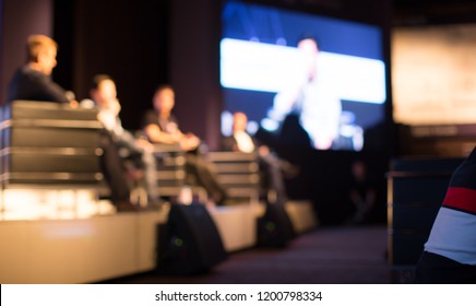 Tech Panel On Stage During Discussion Event. Experts Debate During Business Conference Seminar Presentation. Executives And Entrepreneur Speakers And Presenters In Conference Hall Lecture Series.
