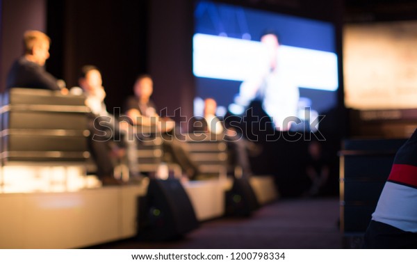 Tech Panel on Stage during Discussion Event.\
Experts Debate during Business Conference Seminar Presentation.\
Executives and Entrepreneur Speakers and Presenters in Conference\
Hall Lecture Series.\
