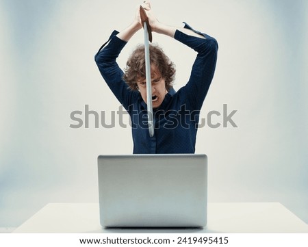 Tech rage personified: one is about to smash their computer with a sword due to anger