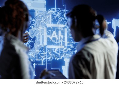 Tech support brainstorms ways to use AI cognitive computing to extract usable information from complex data. Server farm employees implement artificial intelligence to process inference datasets