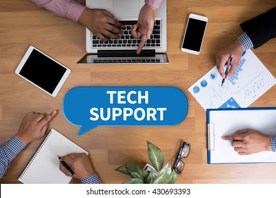 TECH SUPPORT Business Team Hands At Work With Financial Reports And A Laptop, Top View