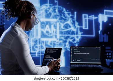 Tech support updates neural networks made of interconnected nodes, writing intricate binary code scripts on tablet and laptop. Server hub employee uses programming to upgrade AI simulation model