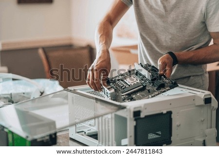 Tech Tactician: Meticulously assembling components, hands guide the central hub of processing power into its chassis, where data will flow and computations will spark.
