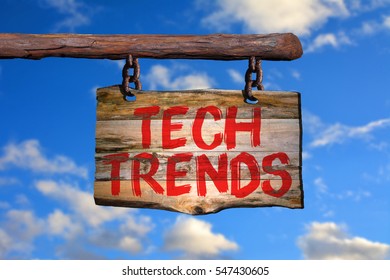 Tech trends motivational phrase sign on old wood with blurred background