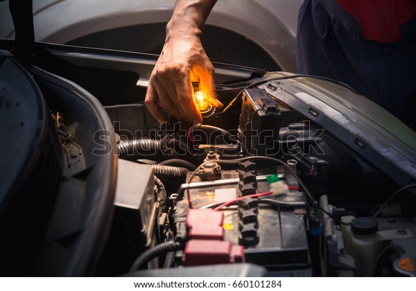 Technicain checking car fuse by lamp tester
which nagative pole of lamp tester connected with car frame and
positive pole measure at secondary of fuse
box.