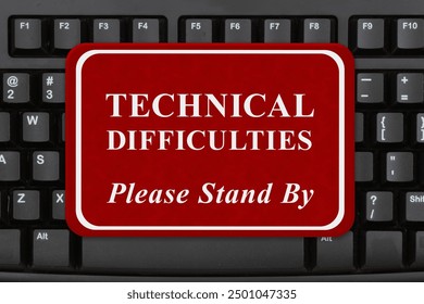  Technical Difficulties please stand by sign on a keyboard