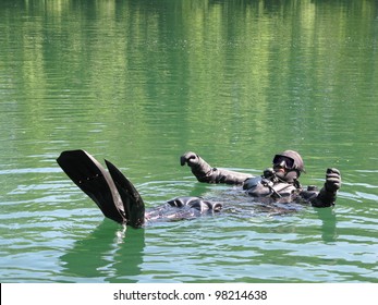 Technical Diver With Dry Suit Floating On The Water Surface After Dive