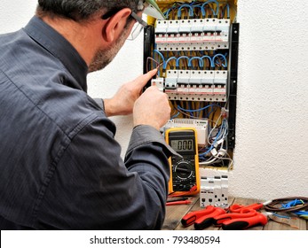 Technical Electrician Fixing The Cable Into The Terminal Of A Circuit Breaker Of A Residential Electrical Panel