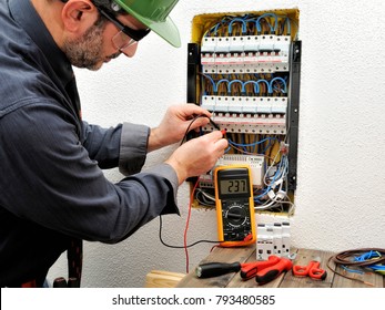 Technical Electrician Measures The Voltage Of A Circuit Breaker Of A Residential Electrical Panel