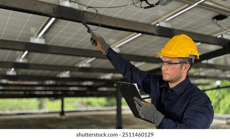 Technical engineer Inspecting the installation of the solar panels and checking the integrity of all wires connected to the solar panels. for the system to work properly