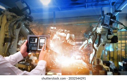  Technical Industrial Engineer control robotics with monitoring system software, Automation robot arm.Welding robotics and digital manufacturing operation.factory automotive industrial concept