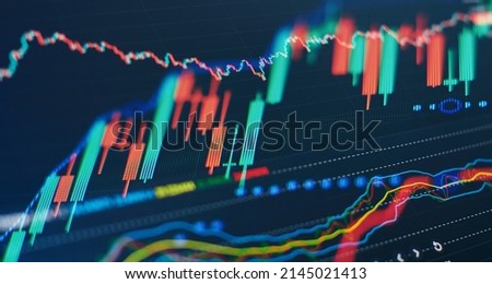 Technical price graph and indicator, red and green candlestick chart on blue theme screen, market volatility, up and down trend. Stock trading, crypto currency background.