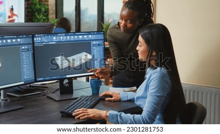 Technical production team of editors using color grading and visual focus to create artistic content montage. Female videographers working for multimedia production in agency studio.