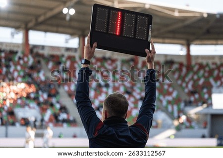 Technical referee shows 1 minute added time during the football match.