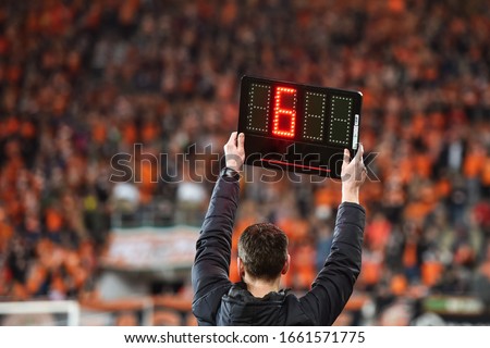 Technical referee shows 6 minutes added time during the football match.