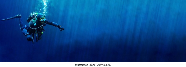 Technical scuba diver in a horizontal position with sun rays blue background. High quality photo. Can be used as a background for a banner - Shutterstock ID 2069864102