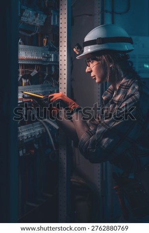 Technical specialist inspecting electrical system with voltage tester. Engineering control.