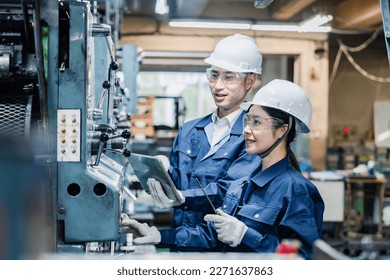 Technical staff working while checking their tablet devices - Powered by Shutterstock