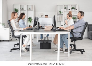 Technical support agents working at table in office