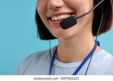 Technical support call center. Smiling operator on light blue background, closeup