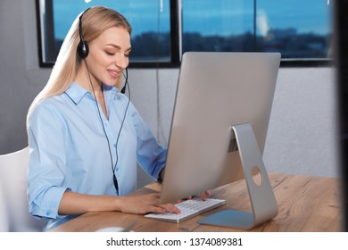 Technical support operator with headset in modern office